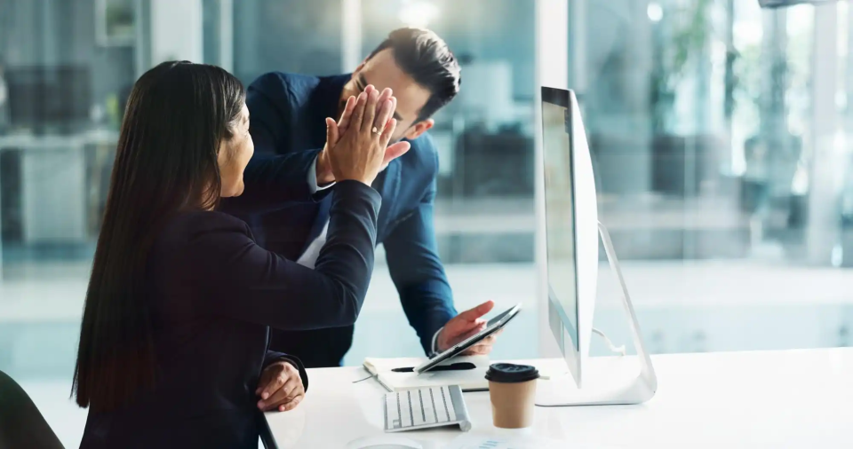 An employee verifying a secure login to assist in preventing digital scams in businesses and identity theft.