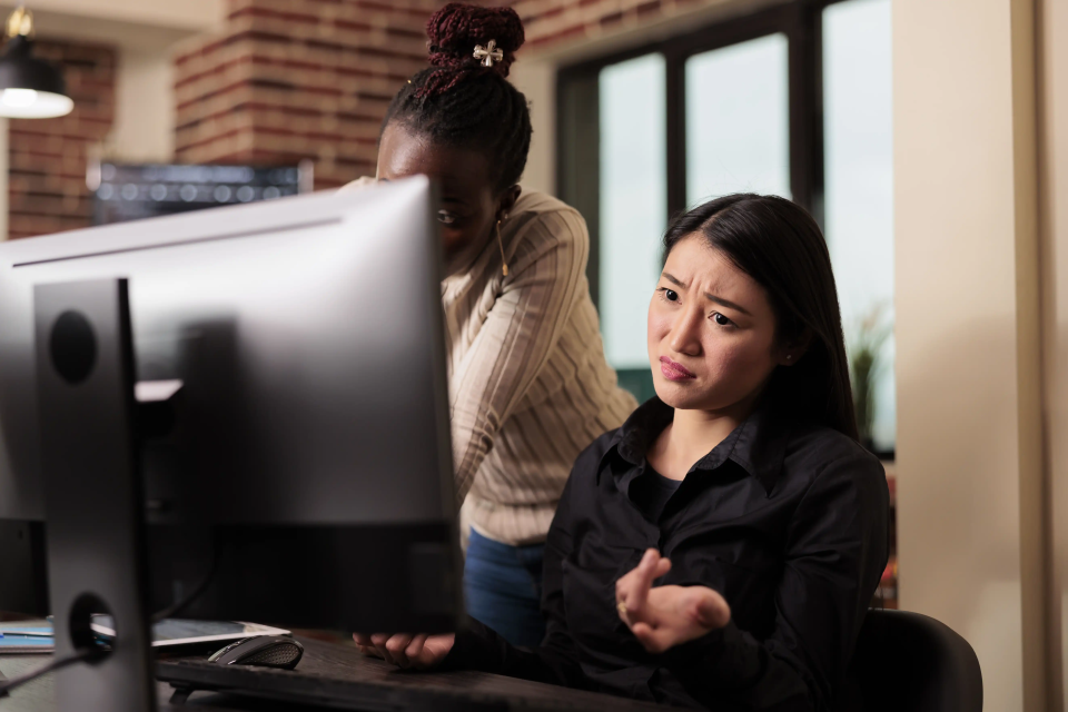 An employee verifying a secure login to assist in preventing digital scams in businesses and identity theft.